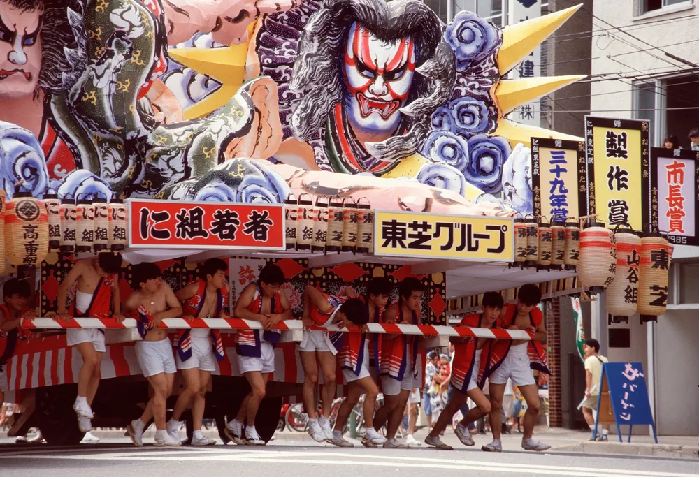 A Nebuta float and haneto dancers at the Aomori Nebuta Festival