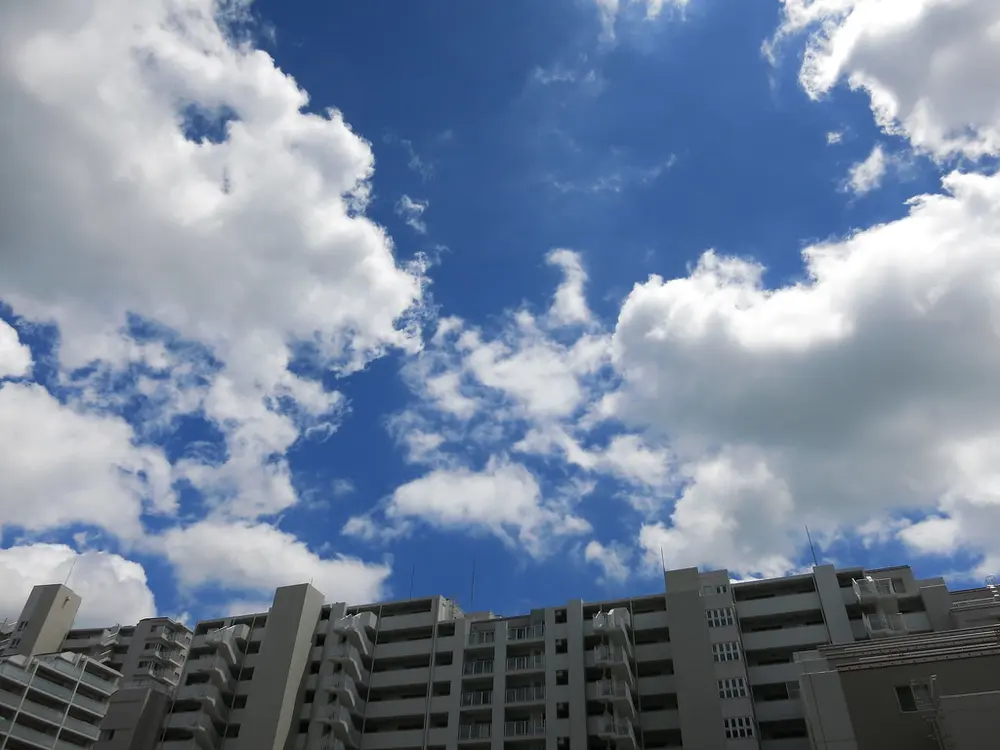 The blazing blue sky and summer clouds of a Japanese midsummer over city buildings